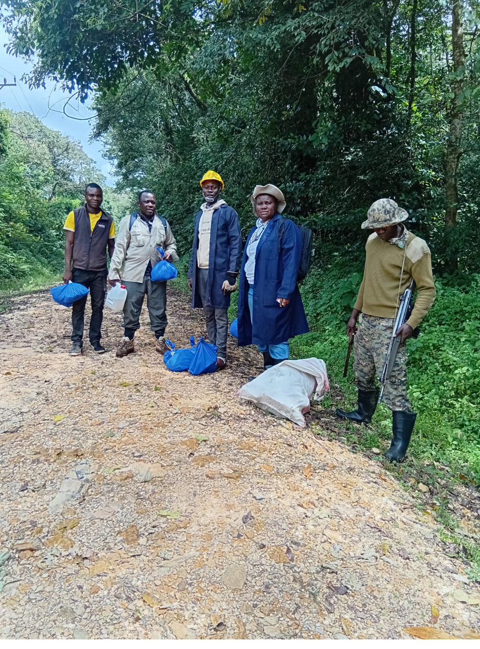 Jairus standing beside a research vehicle in Akagera National Park